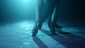 Closeup dancers legs dancing indoors. Partners feet doing latin dance steps. Royalty Free Stock Photo