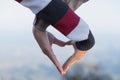 Closeup of couple making heart shape with hands, Couple in love, Focus on hands, Man and woman tourists in the mountains at sunset Royalty Free Stock Photo