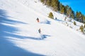 Closeup on couple of skiers going fast on steep piste in Pyrenees Mountains., Andorra