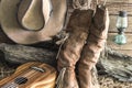 Closeup cowboy hat and boots with ukulele in barn studio Royalty Free Stock Photo