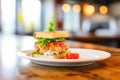 closeup of crab cake sandwich with lettuce in a bistro Royalty Free Stock Photo