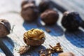 Closeup of cracked open walnut with exposed kernel on rustic wood, surrounded by whole nuts and shells. Fresh walnut half with Royalty Free Stock Photo