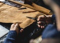 Closeup of craftsman cutting leather handicraft