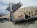 Closeup of crashed plane on small desert hill