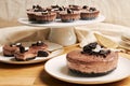 Closeup of creamy chocolate cheesecakes on plates on the table under the lights