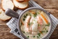 Closeup of creamy fish soup with cod, salmon, carrot and celery in a bowl served with fresh bread. horizontal top view Royalty Free Stock Photo