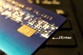 Closeup credit card on black enter button, convenience shopping concept