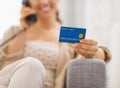 Closeup on credit card in hand of young woman talking phone Royalty Free Stock Photo