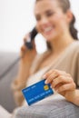 Closeup on credit card in hand of young woman talking phone Royalty Free Stock Photo