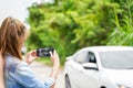 Closeup and crop female driver are using mobile phones to take photos as evidence for insurance claims
