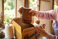 Closeup and crop female seller put the products ordered by customers into the parcel box and prepare to send to customers