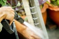 Closeup and crop hands of electric repair technician holding water gun atomizer washing mask of home air conditioner