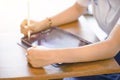 Closeup and crop hands of Student using and study on tablet at school