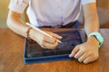 Closeup and crop hands of Student using and study on tablet at school