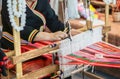 Hands of Thailander Hill tribe ladies are demonstration of weaving colorful fabric for tourists in her village Royalty Free Stock Photo