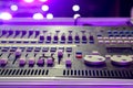 Knobs with button of sound music mixer control panel on blurry and bokeh of party purple lights and flare