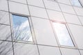 Closeup and crop reflection and shadow of winter tree and bright blue sky on office building windows Royalty Free Stock Photo