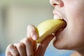 Unrecognizable teenage girl eating apple slice at home Royalty Free Stock Photo