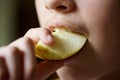 Crop unrecognizable young girl biting fresh juicy apple piece Royalty Free Stock Photo