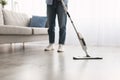 Low section of woman cleaning floor with spray mop Royalty Free Stock Photo