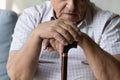 Closeup cropped old man holding hands on walking cane. Royalty Free Stock Photo