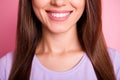 Closeup cropped photo of beautiful woman with brunette hair smiling with white teeth isolated on pastel pink color