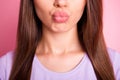 Closeup cropped photo of beautiful woman sending air kiss with pouted plump lips isolated on pastel pink color Royalty Free Stock Photo