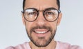 Closeup cropped portrait of handsome young serious bearded male model look at the camera, wears round trendy glasses with toothy Royalty Free Stock Photo