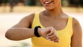 Sporty African woman checking fitness tracker during workout break Royalty Free Stock Photo