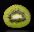 closeup cross section of ripe juicy kiwi fruit on black background