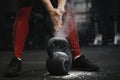 Closeup of crossfit female athlete claping hands with cloud of dust while magnesia protection Royalty Free Stock Photo