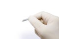 Closeup and croup hand of doctor in white medical glove and shadow holding blood lancet isolate on white background