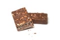 crunched chocolate bar with nuts on white background