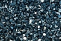 Closeup crushed stone background.Black small road stone dark gravel pebbles stone texture backdrop natural pattern for architectur