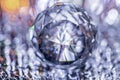 Closeup of crystal glass faceted ball on background of festive lights. Abstract festive, christmas or interior background.