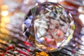 Closeup of crystal glass faceted ball on background of festive lights. Abstract festive, christmas or interior background.