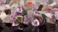 closeup crystals of amethyst, fluorite, jasper, carnelian and rose quartz on black table. Selective Focus