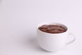 Closeup of a cup of hot chocolate drink on a white surface Royalty Free Stock Photo