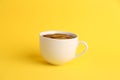 Closeup of a cup of hot chocolate isolated on a yellow background Royalty Free Stock Photo