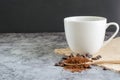 Closeup cup of hot coffee and ground coffee. Royalty Free Stock Photo