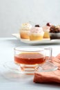 closeup cup of tea with cupcakes in the background Royalty Free Stock Photo