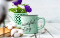 Closeup of a cup of tea on a wooden white table with blur background, front blur. Flat lay. Still life of a flower, a book, a box Royalty Free Stock Photo