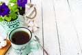 Closeup of a cup of tea on a wooden white table with blur background, front blur. Flat lay. Still life of a flower, a book, a box Royalty Free Stock Photo