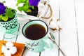 Closeup of a cup of tea on a wooden white table with blur background, front blur. Flat lay. Still life of a flower, a book, a box Royalty Free Stock Photo