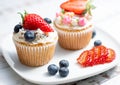 Closeup Cupcakes with blueberry and strawberry on white plate