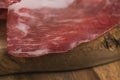 Closeup cured italian coppa on olive wood board