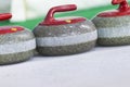Closeup of Curling Blue Handle Stones on Ice.With Copyspace