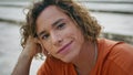 Closeup curly relaxed guy with piercing sitting at street. Portrait man hipster Royalty Free Stock Photo