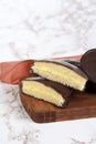 Closeup of custard filled chocolate sponge cake with a napkin