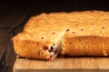 Closeup of a cut piece of berry pie on a cutting board